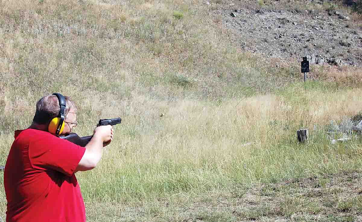 Mike shooting steel with the Inglis Hi-Power with the shoulder stock mounted.